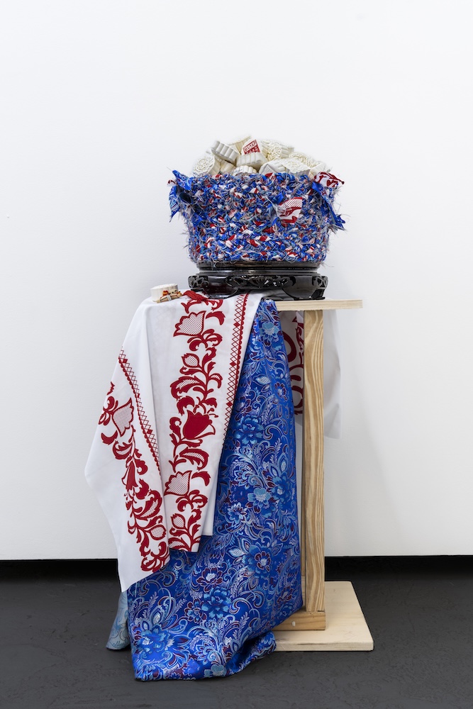 Over the Moon, installation view. Sculpted mooncakes, nest of traditional Panamanian pollera fabrics, and traditional Chinese tapestries. Image by Zaire Aranguren. Courtesy of the artist.